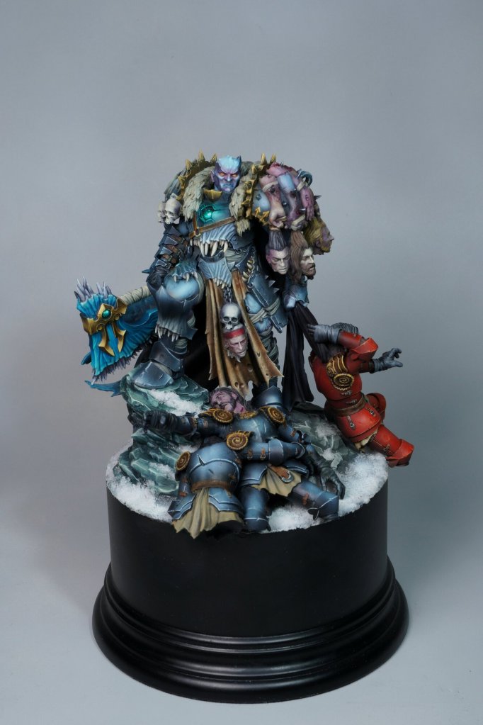 A detailed fantasy figurine sculpture depicting warriors and mythical characters, arranged on a black circular base, showcasing craftsmanship and fantasy themes.